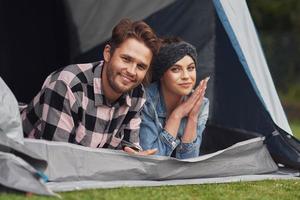 Young nice couple having fun on camping photo