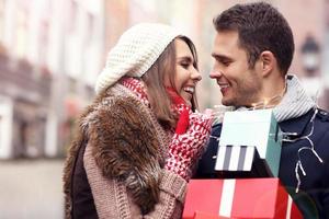 Happy couple shopping for Christmas in the city photo