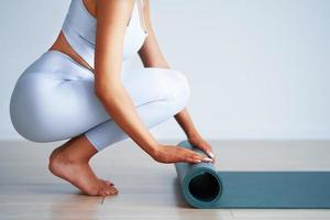 Adult beautiful woman working out over light background photo