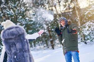 Couple having fun in winter scenery and snow photo