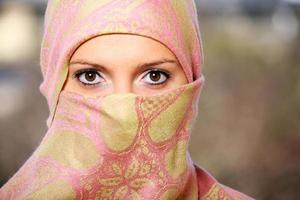 Muslim woman hidden behind a scarf photo