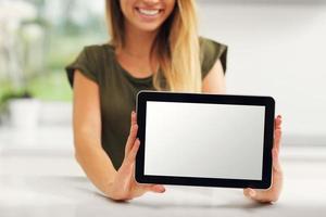 Young woman with tablet in kitchen photo