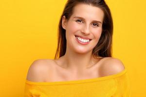 Woman against yellow wall background photo