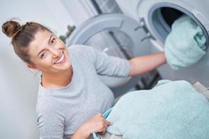 Picture of young woman making laundry work photo