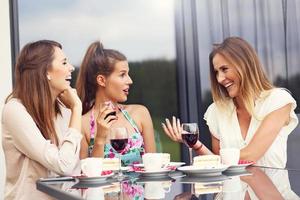 Group of friends chatting in cafe photo