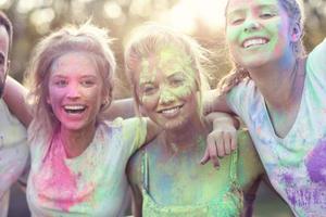 Group of friends having fun at color festival photo