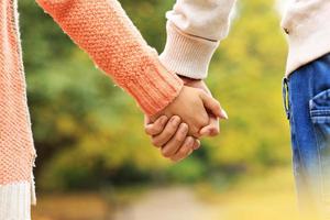 Couple holding hands in the park photo