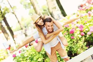 Romantic couple doing piggyback in the park photo