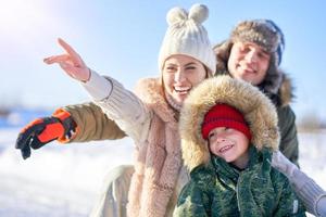 Nice happy family having fun on winter snow photo