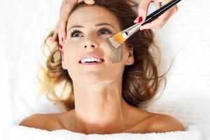 Woman with facial mask in beauty salon photo