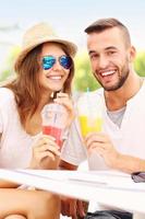 Joyful couple and smoothies in a cafe photo
