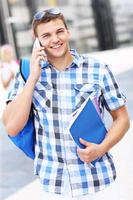 Handsome student talking on the phone photo