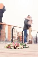 Flowers and hugging couple photo