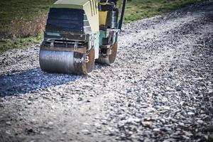 Picture of a road roller machine on the different surfaces photo