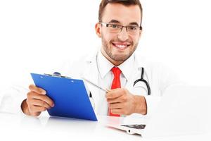 Doctor with laptop and documents photo