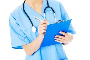 Midsection Of Nurse Writing On Clipboard photo