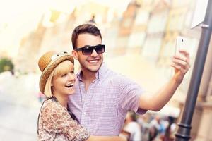 Young couple taking selfie while sightseeing the city photo