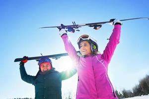 Young couple having fun while winter skiing photo