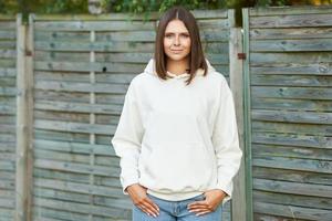 Young woman in white hoodie. photo