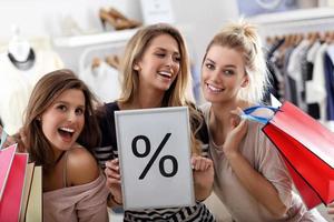 Group of happy friends shopping in store photo