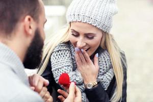 hombre adulto dando anillo de compromiso a mujer hermosa foto