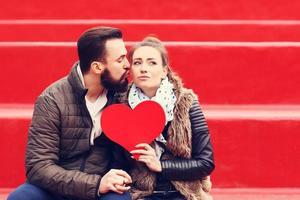 Romantic couple holding heart photo