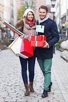 Happy couple shopping for Christmas in the city photo