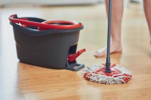 Picture of bucket and mop on the wooden floor