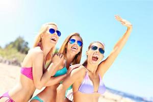 Group of women having fun on the beach photo