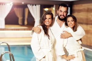 Group of friends relaxing in pool spa photo