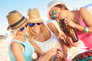 Girl friends on picnic on the beach photo