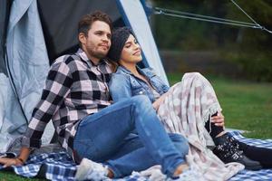 Young nice couple having fun on camping photo