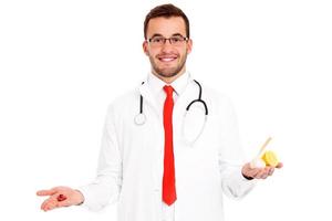 Doctor showing pills and garlic with lemon photo