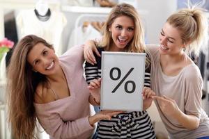 Group of happy friends shopping in store photo