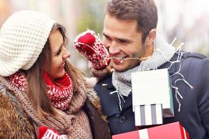 Happy couple shopping for Christmas in the city photo