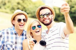 Group of friends taking a picture in the park photo