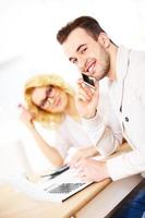 Young happy couple working on documents at home photo