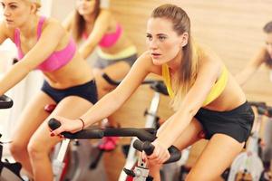 Sporty women on spinning class photo