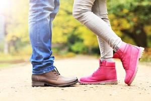 Couple's legs in the park in autumn photo