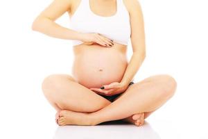 Expecting time. Pregnant woman sitting down photo