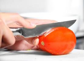 Cutting red tomato photo