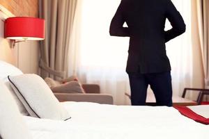 Silhouette of businessman in hotel room photo