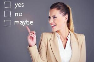 Businesswoman choosing between yes and no photo