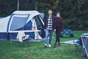 Young nice couple having fun on camping photo