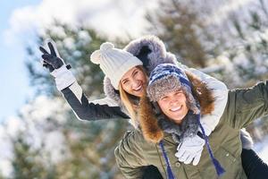 Couple having fun in winter scenery and snow photo