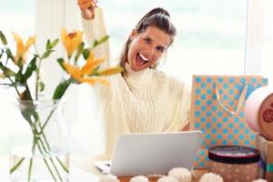 Adult woman wearing warm sweater and shoping online photo