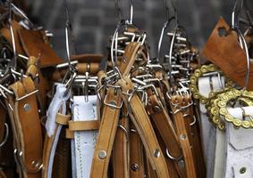 Leather belts in a market photo