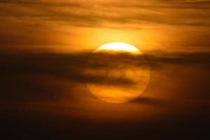 Sun setting over the sea, sunset in autumn on the beach of Zahara de los atunes, Cadiz, Andalucia, Spain photo