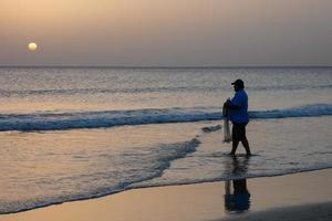 Sun setting over the sea, sunset in autumn on the beach of Zahara de los atunes, Cadiz, Andalucia, Spain photo