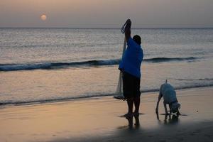 Sun setting over the sea, sunset in autumn on the beach of Zahara de los atunes, Cadiz, Andalucia, Spain photo